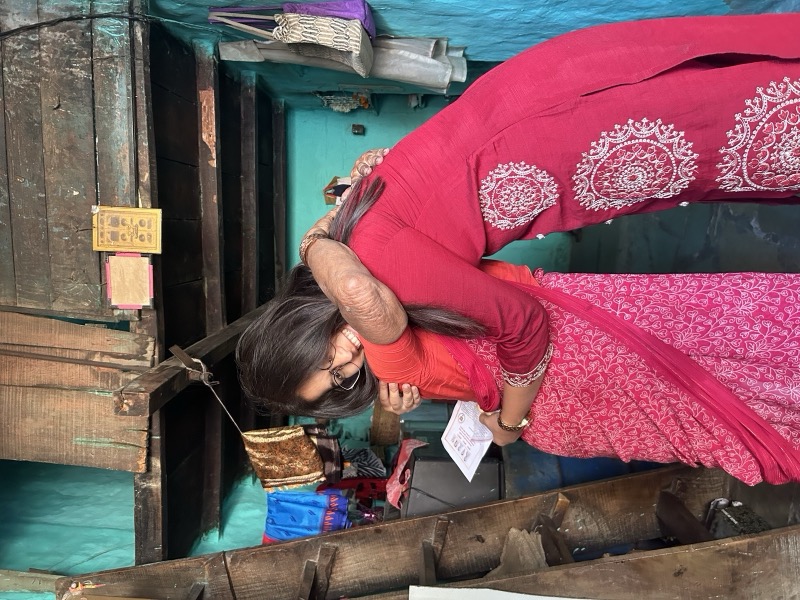 Siddhali Anup Shah visiting a resident at her doorway in Phaltan