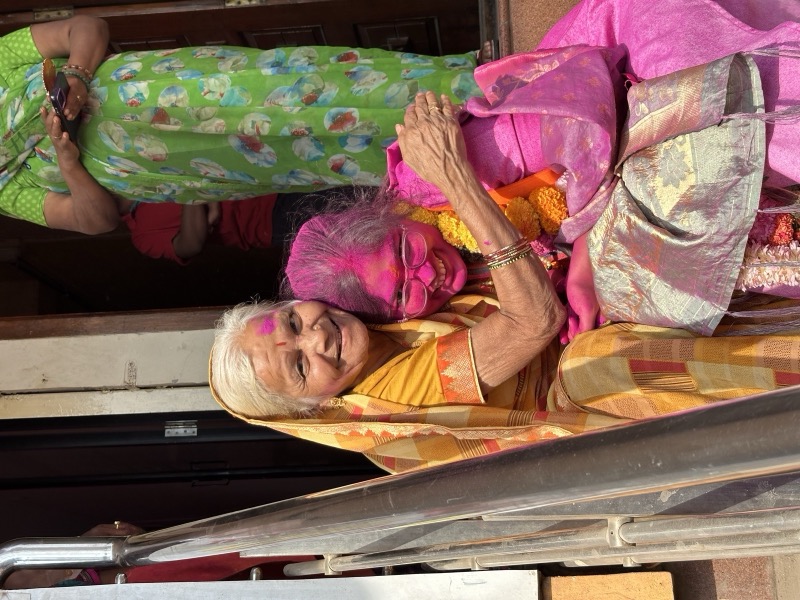 Siddhali Anup Shah greeting an elderly woman at her home