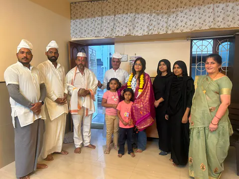 Siddhali Anup Shah with residents at an indoor community gathering