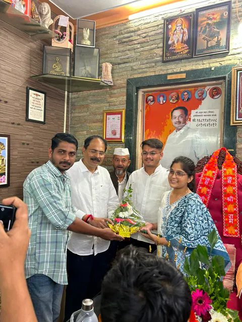 Siddhali Anup Shah receiving flowers during an office visit